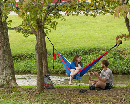Students sitting by Kings Creek