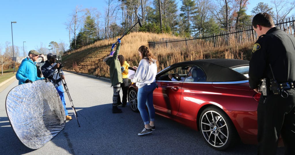 students work together on the PSA filming set