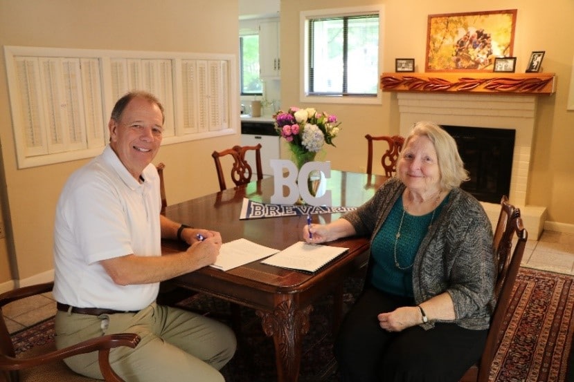 President David C. Joyce and President of the Brevard College Alumni Association, Jenny Munro, sign the scholarship agreement.